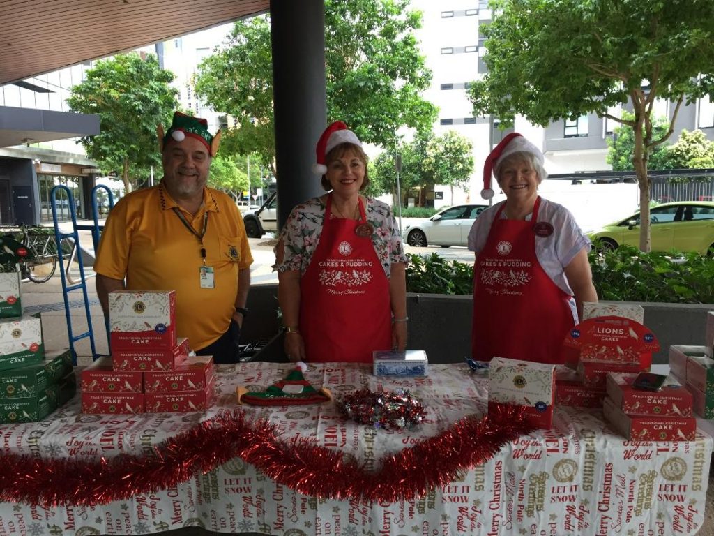 Lions volunteers selling Christmas cakes and puddings at a stall