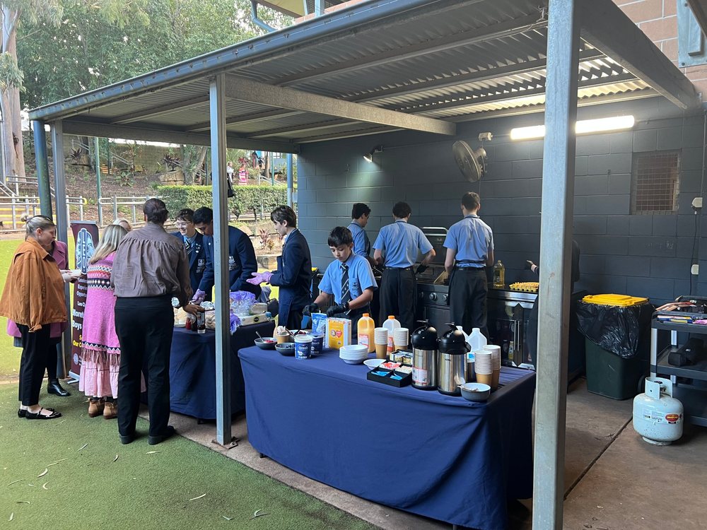 Leos from Moreton Bay Boys’ College serving breakfast at a school event